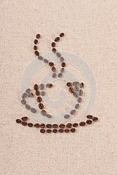 Coffee cup made of beans on linen