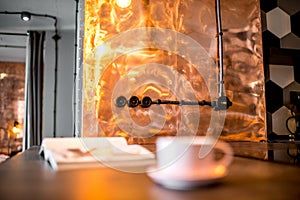 Coffee cup and magazine on the kitchen table
