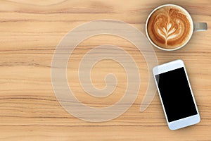 Coffee cup and mobile phone on teak wood texture background.
