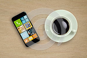 Coffee cup and Mobile phone on wood table