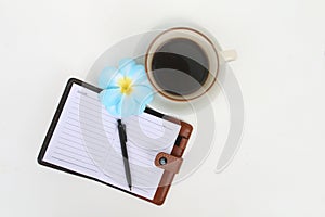 Coffee cup and notbook on white background