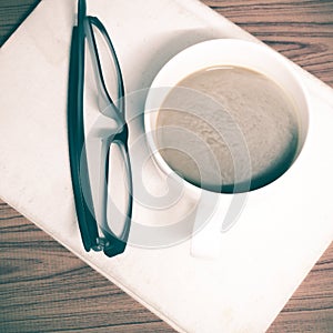 Coffee cup and notebook with glasses photo