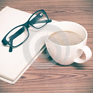 Coffee cup and notebook with glasses photo