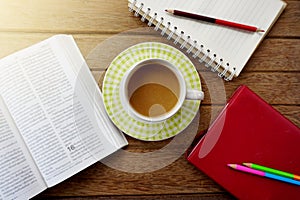 coffee cup,notebook,pencils on dark wooden table