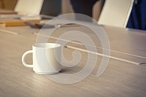 Coffee cup on the office desk, business background concept