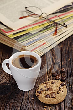 Coffee cup and old magazines