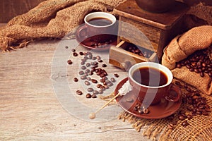 Coffee cup and old vintage coffee grinder on wooden table