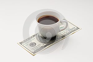 Coffee cup and one hundred U.S. dollars