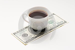 Coffee cup and one hundred U.S. dollars