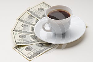 Coffee cup and one hundred U.S. dollars