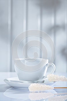 Coffee cup and other items on white table