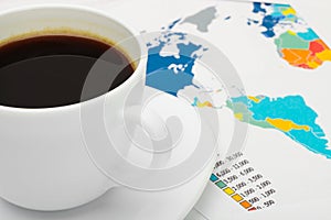 Coffee cup over world map - business concept