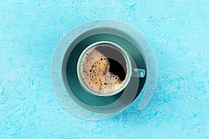 Coffee cup, overhead flat lay shot on a blue background, espresso drink