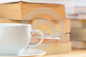 Coffee cup with pile of book blackground