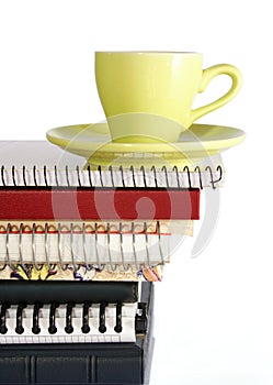 Coffee Cup on Pile of Notebook