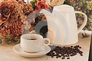 Coffee cup and pot on marble table photo