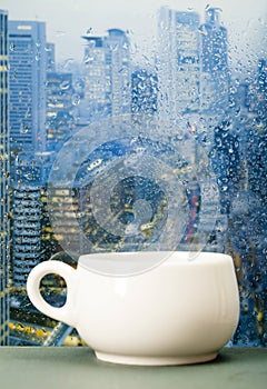 Coffee cup on a rainy day in front of the window