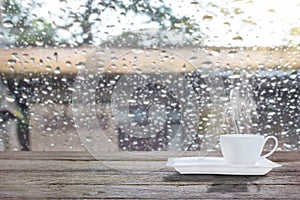 Coffee cup on a rainy day with morning sunlight