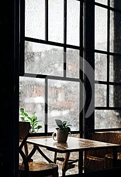 Coffee cup on a rainy day window background in cafe. Sad mood. Digital art illustration