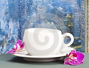 Coffee cup on a rainy day on window background