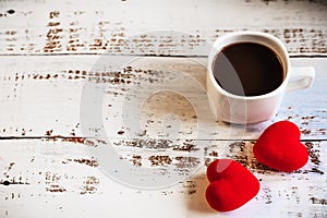 coffee Cup and red hearts on a white wooden background. Valentine's day. Place for text, place for copying.
