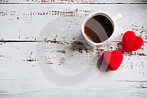 coffee Cup and red hearts on a white wooden background. Valentine's day. Place for text, place for copying.