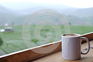 Coffee cup with rice field background