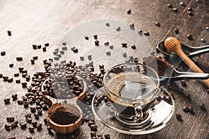 Coffee cup and roasted coffee beans In the bag and honey on a wooden table background