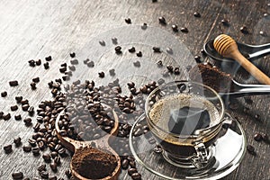 Coffee cup and roasted coffee beans In the bag and honey on a wooden table background