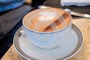 Coffee in cup and saucer with beautiful presentation.