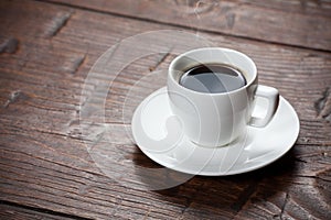 Coffee cup and saucer on wooden table