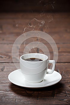 Coffee cup and saucer on wooden table