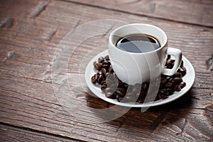 Coffee cup and saucer on wooden table