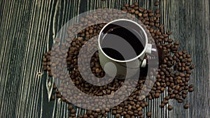 Coffee cup and saucer on a wooden table, dark background with clipping path