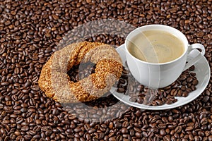 Coffee cup and simit sesame bagel from above.
