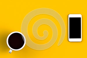 Coffee cup with smart phone on yellow background, Top view with copyspace for your text