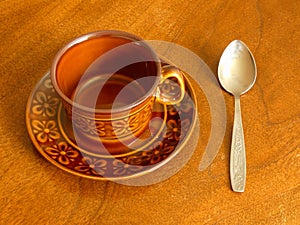 Coffee Cup and Spoon On Wooden Table