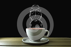 Coffee cup with steam in alarm clock shape on wooden plank with black background. Good morning coffee or time to think or creative