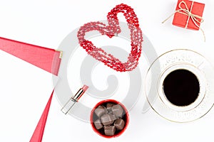 Coffee cup, sweets, lipstick, heart shape and giftbox on white background. Valentine`s Day concept flat lay.