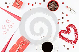 Coffee cup, sweets, lipstick, heart shape and giftbox on white background. Valentine`s Day concept frame.