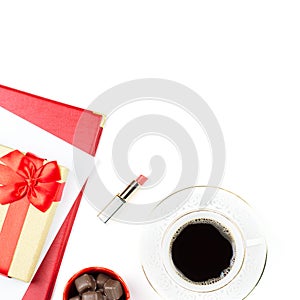 Coffee cup, sweets, lipstick, heart shape and giftbox on white background. Women`s Day concept flat lay.