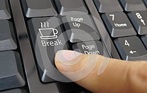 Coffee cup symbol button on computer keyboard with finger, Business coffee break time.