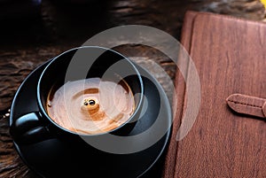 Coffee cup on the table near book in the morning