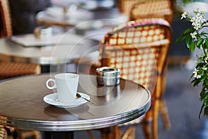Coffee cup on a table of Parisian outdoor cafe