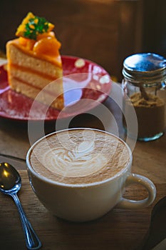 Coffee cup and tasty cake on wood table and Blank paper waiting for ideas , coffee time work