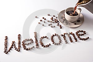 Coffee cup and text made of coffee beans, isolated on white. text the word Welcome made of coffee beans. font