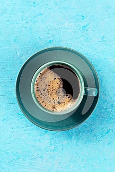 Coffee cup, top shot on a blue background, espresso drink