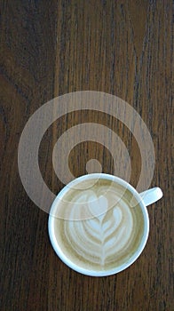 Coffee cup top view on wooden table background