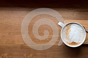 Coffee cup top view on wooden table background