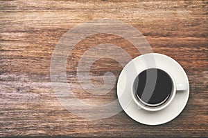 Coffee cup top view on wooden table background.